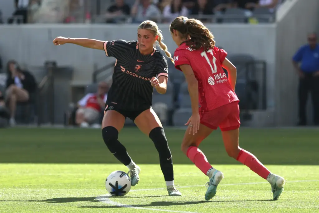 Angel City FC forward Riley Tiernan, left, moves the ball...