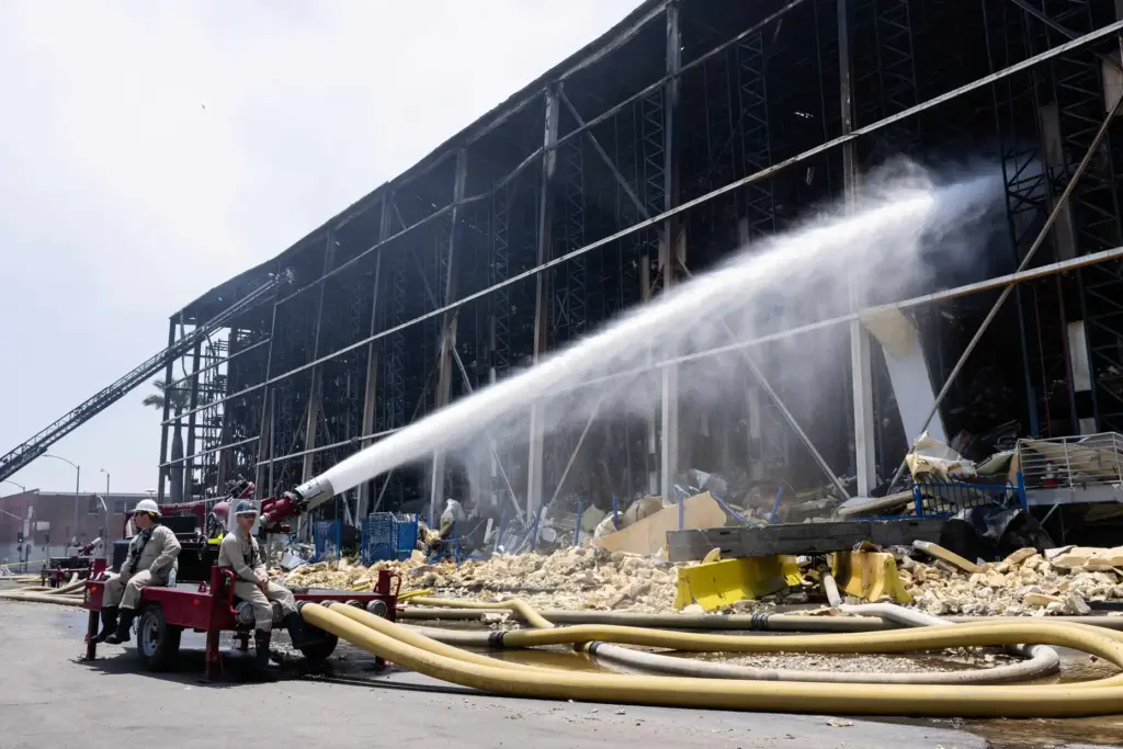 Firefighters and emergency crews continue to extinguish a smouldering cold...