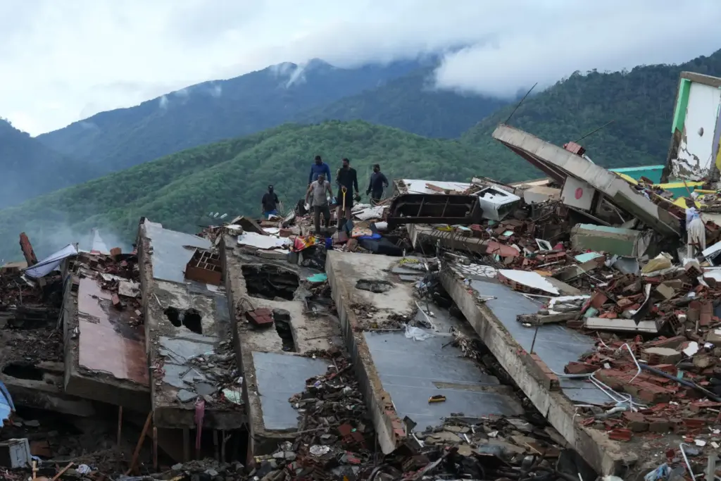 Residents search through the rubble of a building that collapsed in the earthquakes.