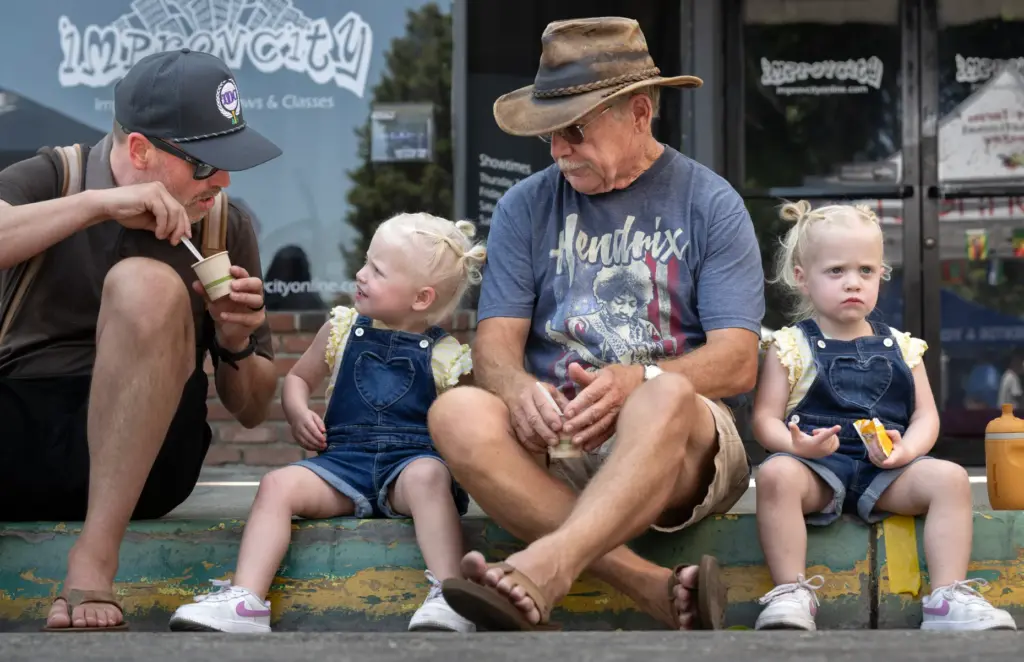 Bryan Uecker, left, offers his daughter, Sailor, 2, some chili...
