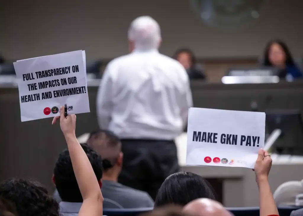 Residents hold up signs critical of GKN Aerospace as the...