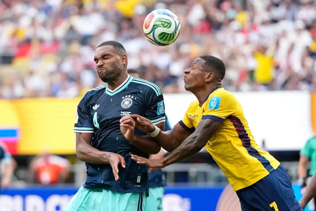 Ecuador’s Pervis Estupinan, right, and Germany’s Jonathan Tah vie for...