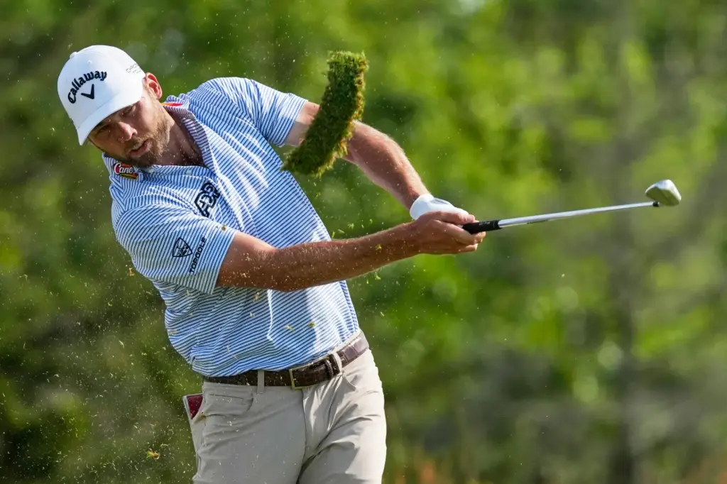 Sam Burns hits his tee shot on the 11th hole...