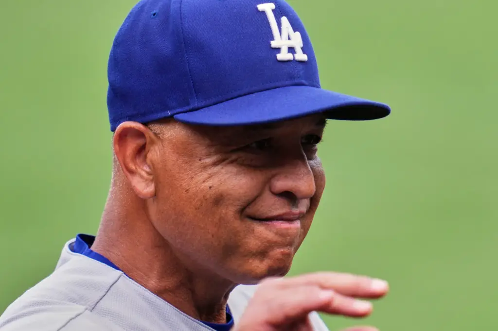 Dodgers manager Dave Roberts waves to a fan before a...