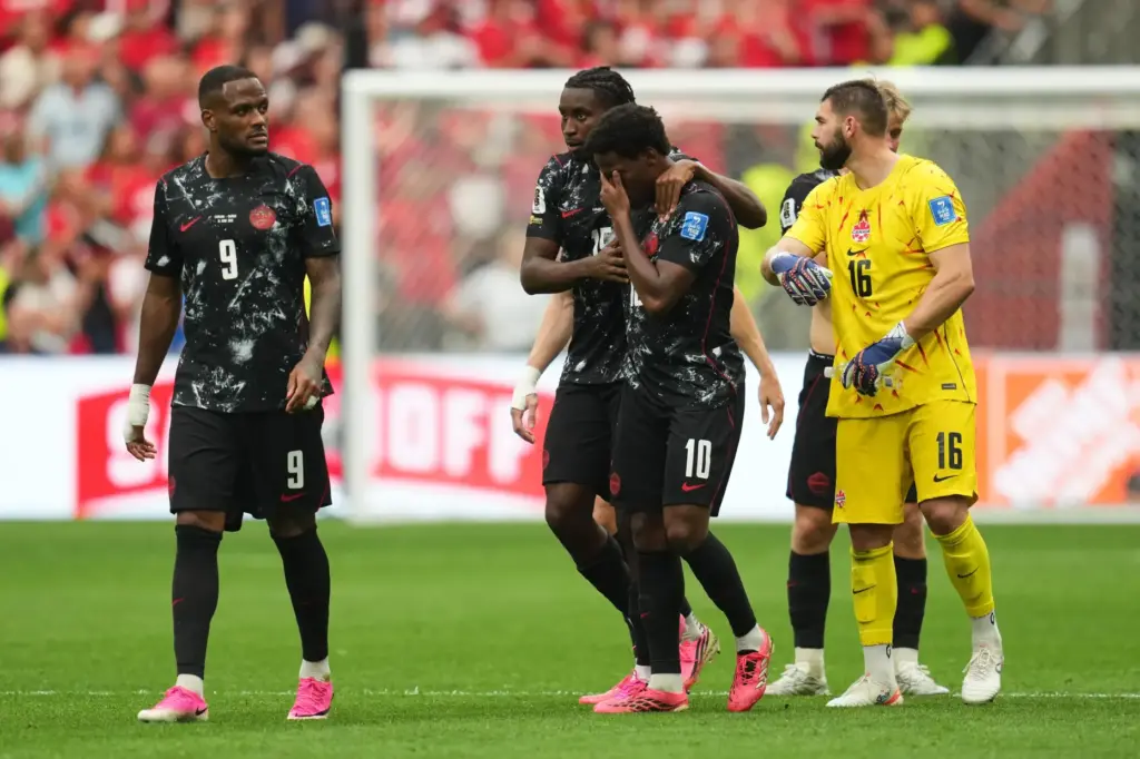 Canada’s Jonathan David, third from left, becomes emotional after Ismael...