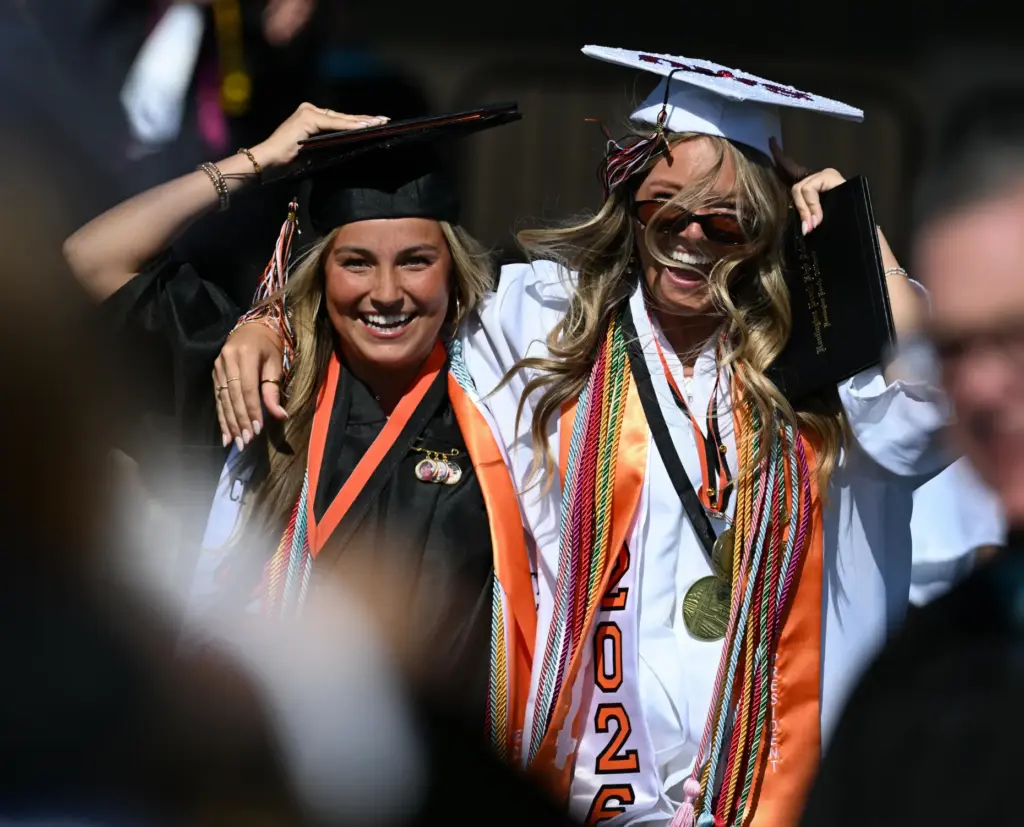 Charlotte Yadrick, left, and Lily Greenfield, Magnaa Cum Laude, celebrate...