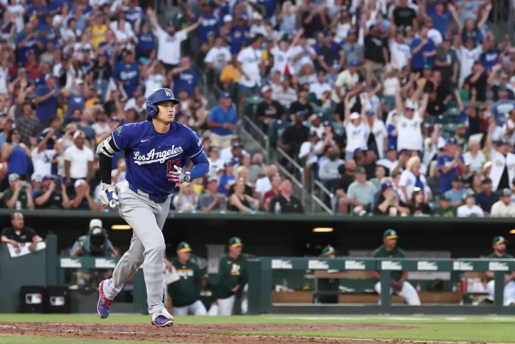 Dodgers star Shohei Ohtani begins to run the bases after...