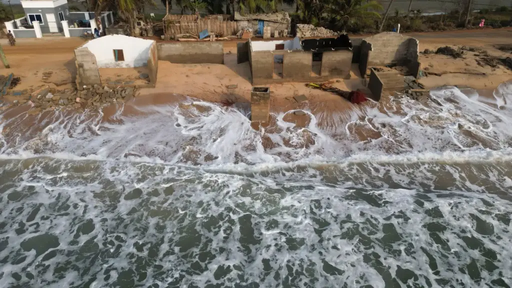 FILE – Waves lap the beach where remains of Afeli...