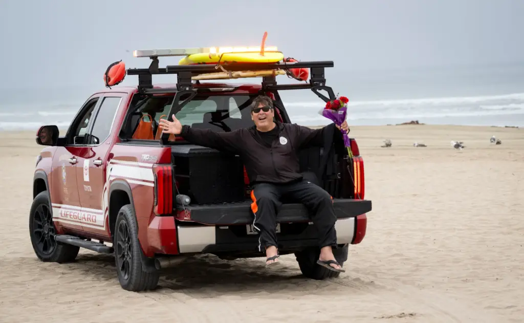 Huntington Beach High School surfing coach Andy Verdone is given...