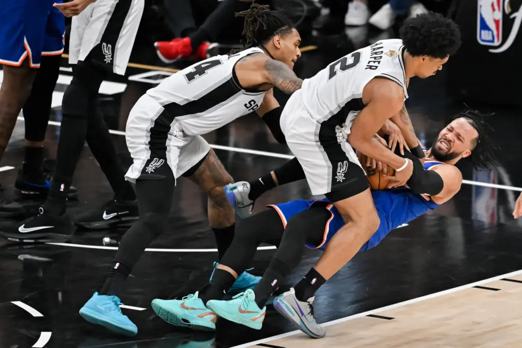 New York Knicks guard Jalen Brunson falls as he pressured...