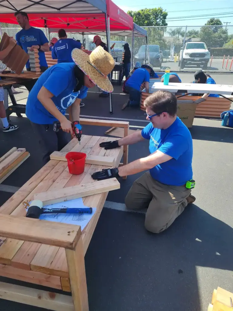 Volunteers build a bench for the garden at Walt Disney...