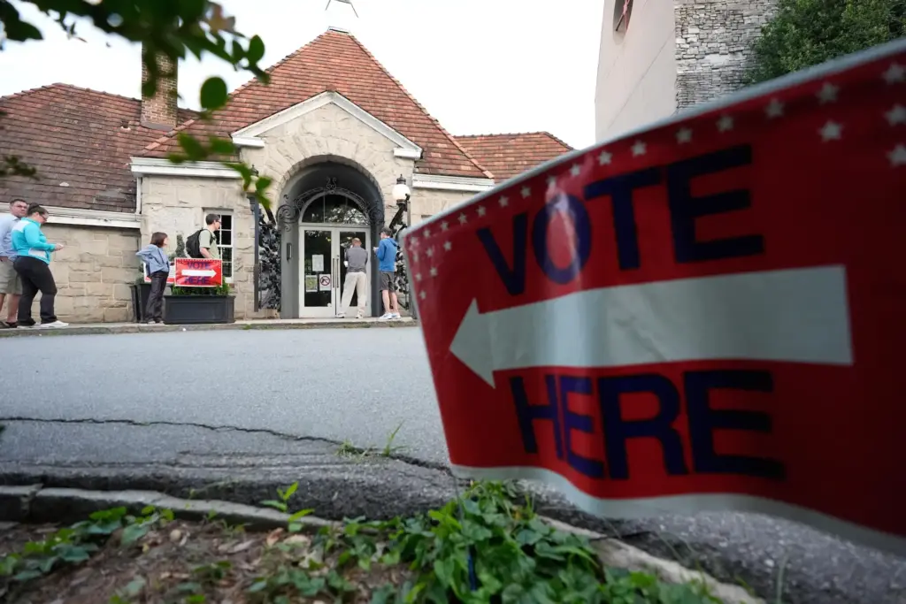 People wait in a line at a precinct before voting...