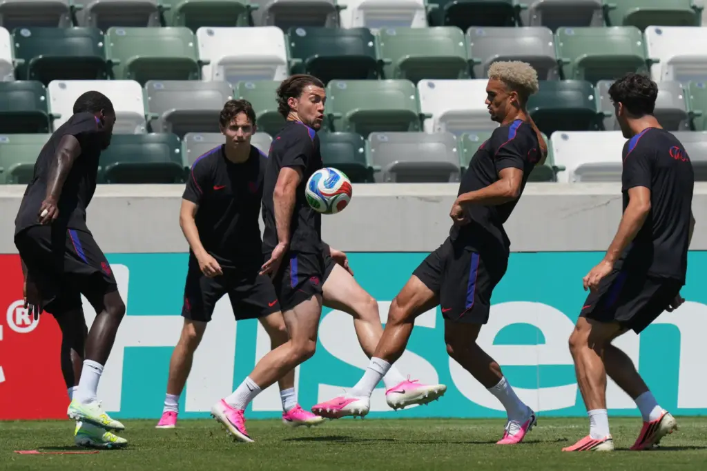United States’ Joe Scally, center, Antonee Robinson, center right, and...