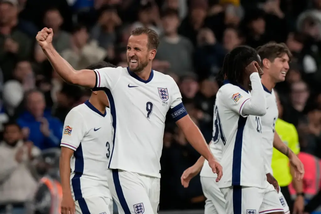 FILE – England’s Harry Kane, left, celebrates after scoring his...
