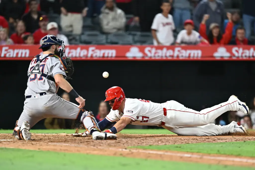 Angels star Mike Trout slides for the plate as the...