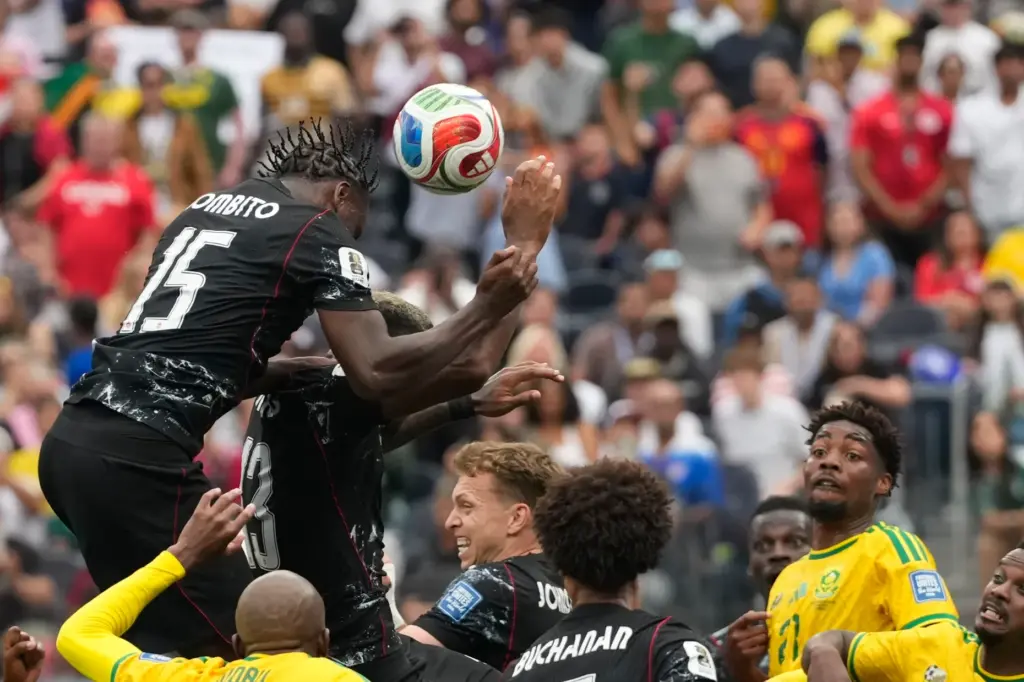 Canada’s Moise Bombito head the ball during the World Cup...