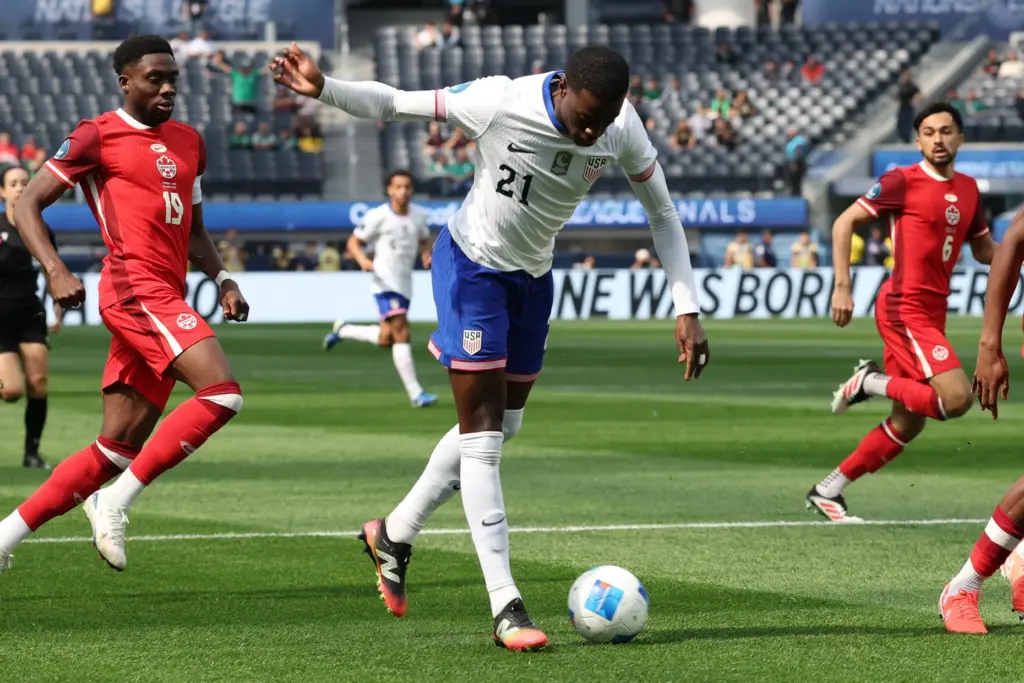 United States forward Tim Weah (21) kicks the ball against...