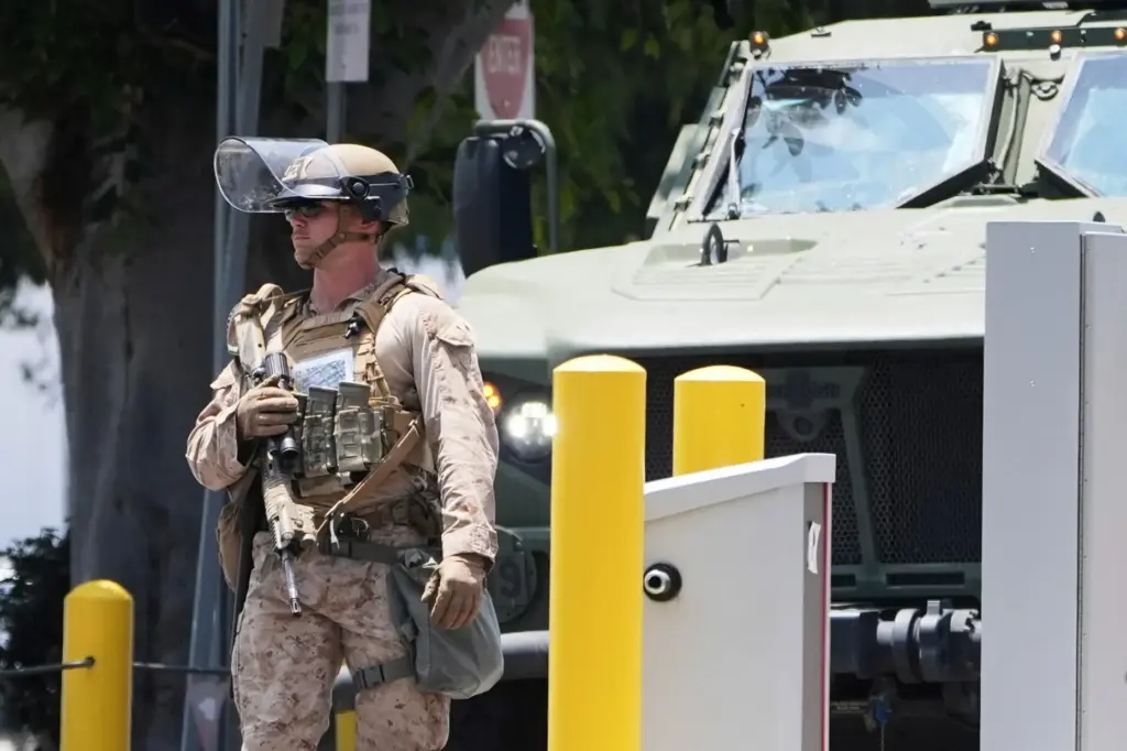 FILE – A U.S. Marine patrols outside of a federal...