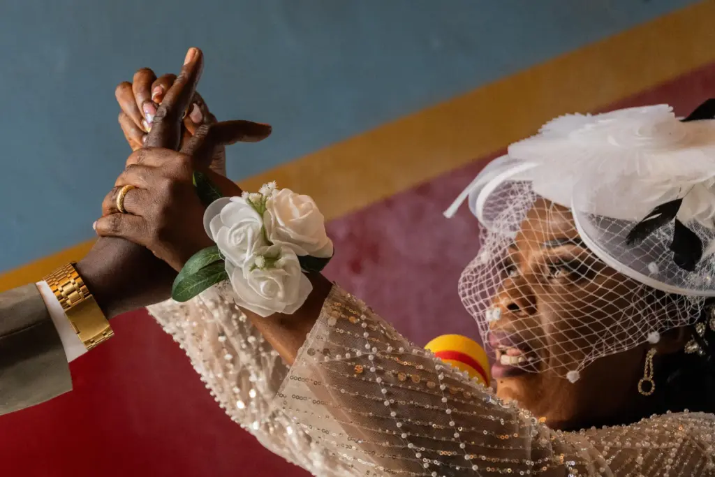 A bride puts a ring on the groom's finger during a wedding ceremony.