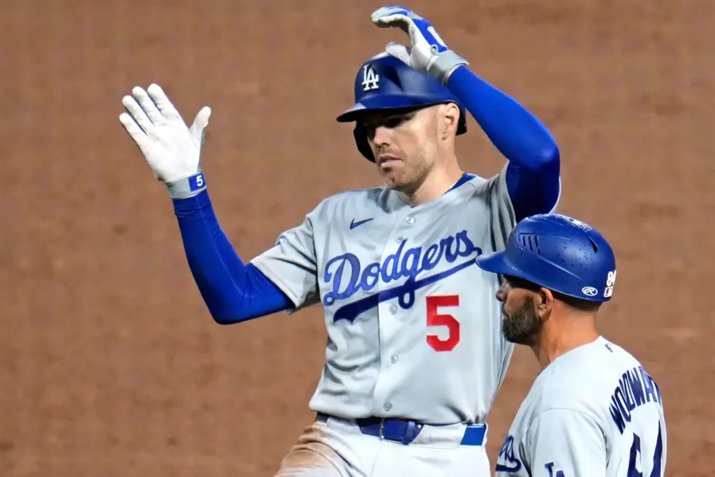 The Dodgers’ Freddie Freeman, left, celebrates next to first base...
