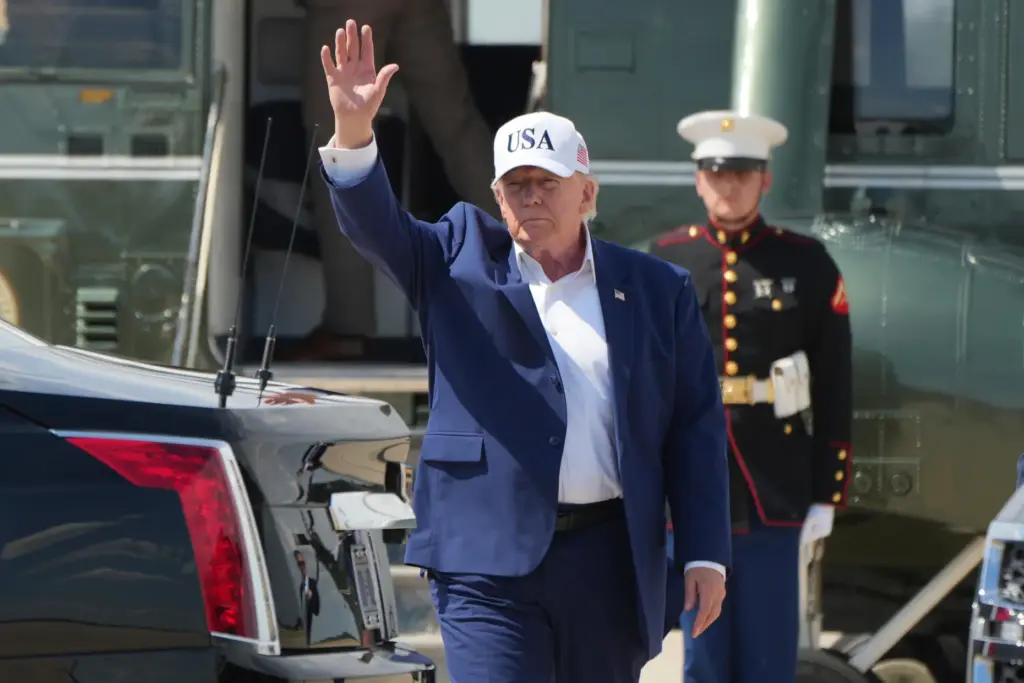 President Donald Trump waves as he arrives on Marine One.