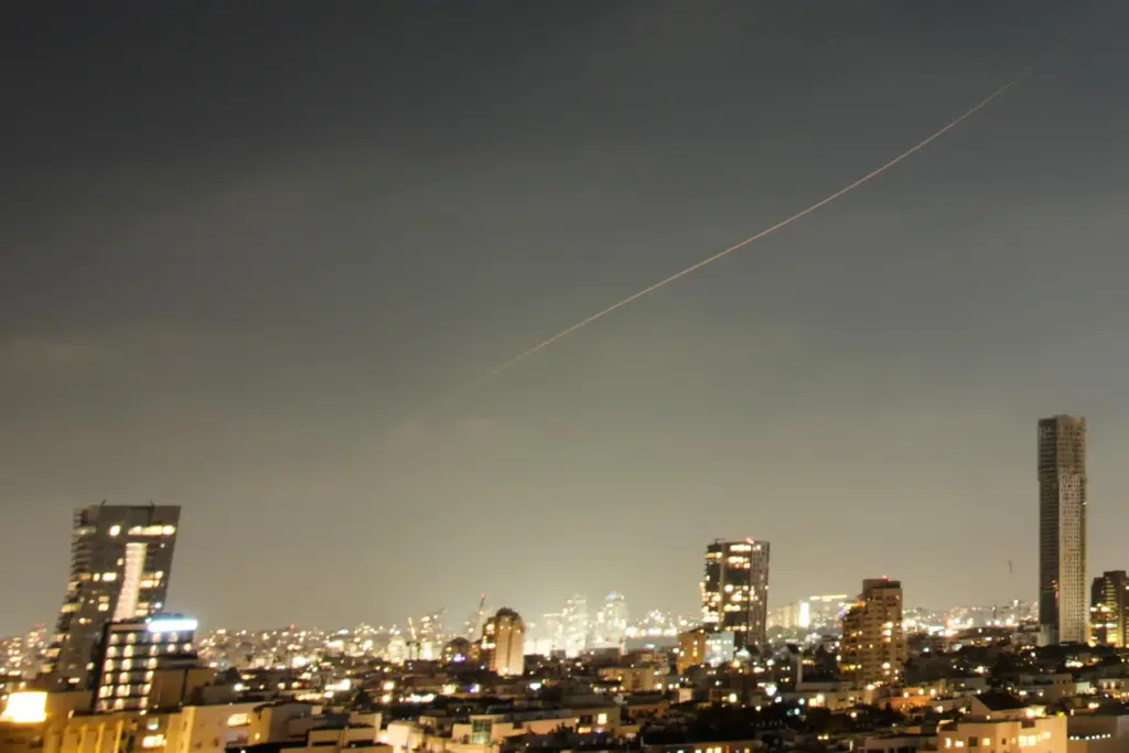 A projectile streaks through the sky over central Israel during an Iranian missile attack.