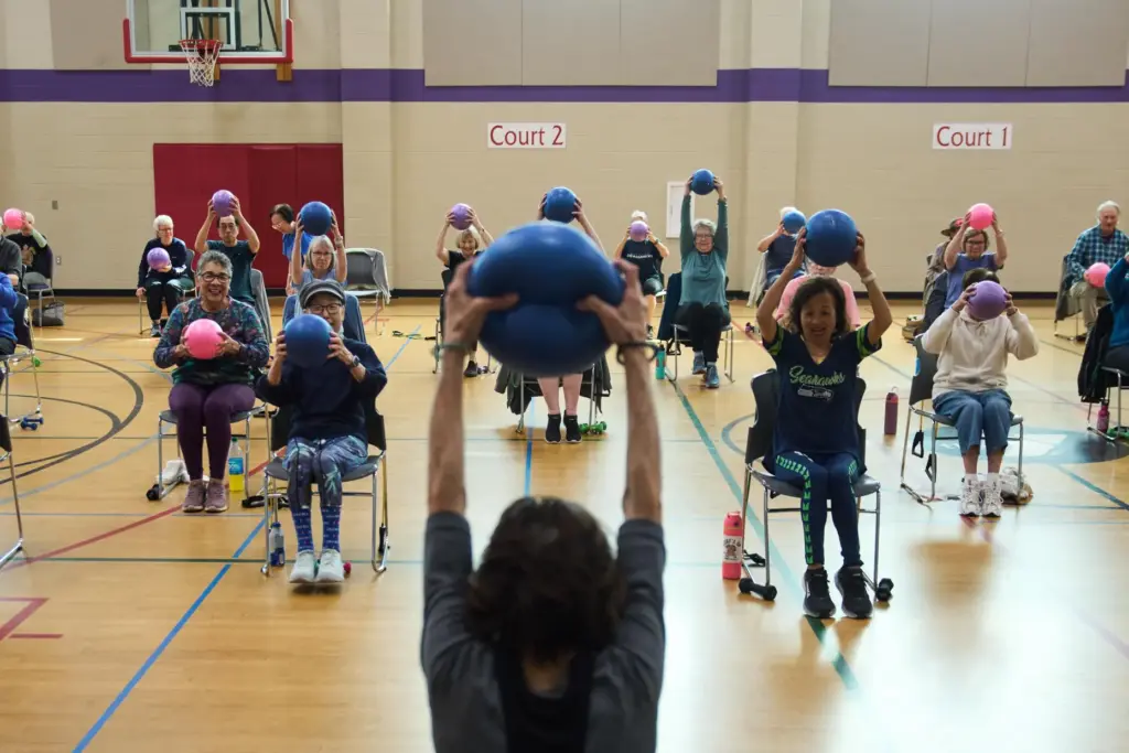 Instructor Bengie Santos, 72, leads a class for older adults.