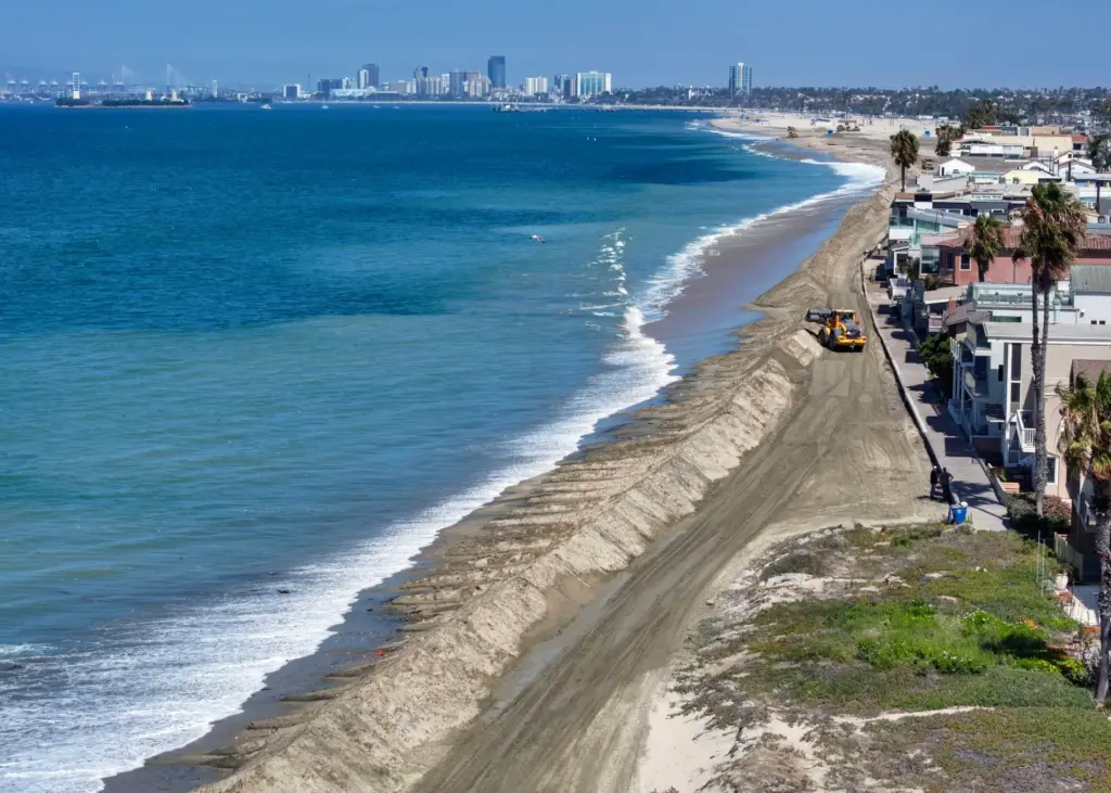 A berm is built in the sand to protect homes...