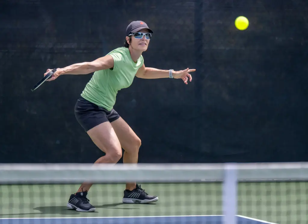 Nora Witt of Mission Viejo returns a serve while competing...