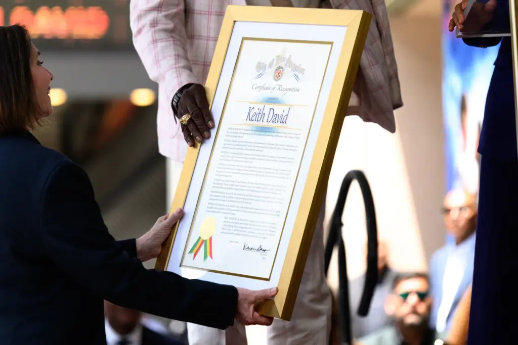 Hollywood Walk of Fame producer Ana Martinez hands Keith David...