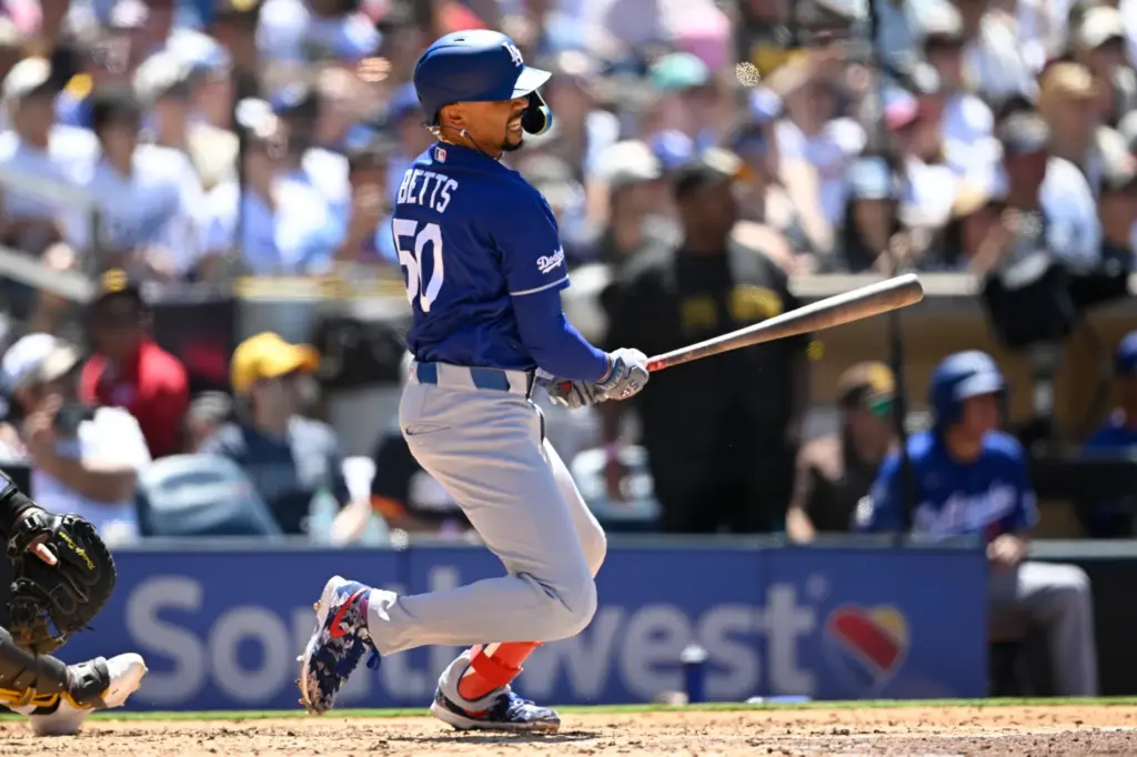 Dodgers’ Mookie Bettswatches his RBI single during the fifth inning...
