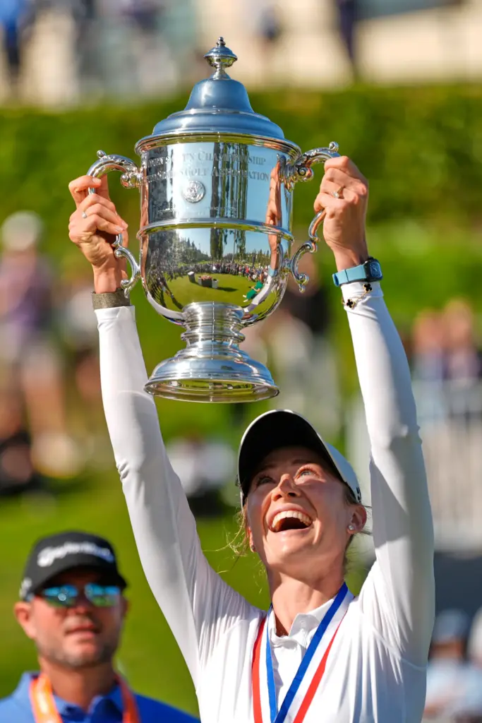 Nelly Korda holds up the trophy after winning the U.S....