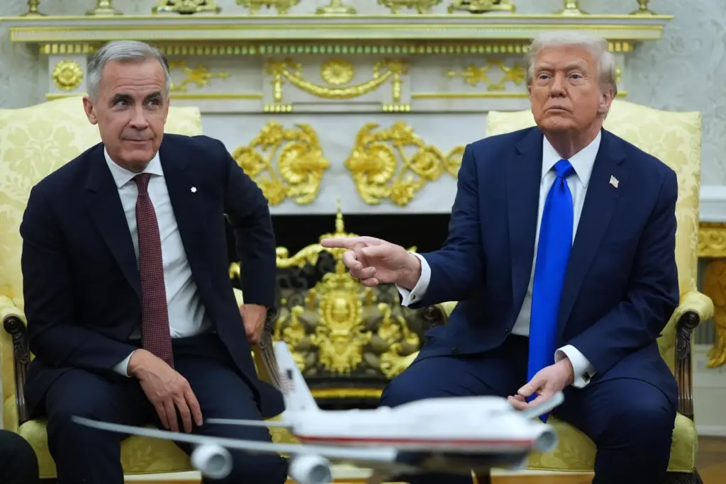 FILE – President Donald Trump gestures alongside Canadian Prime Minister...