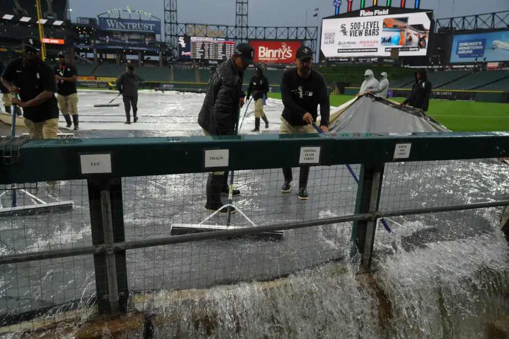 White Sox grounds crew remove water from the field after severe thunderstorms came through Chicago.