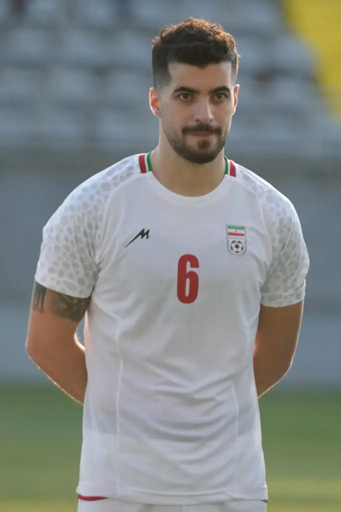 Iran’s Saeid Ezatolahi listens to national anthems prior to a...