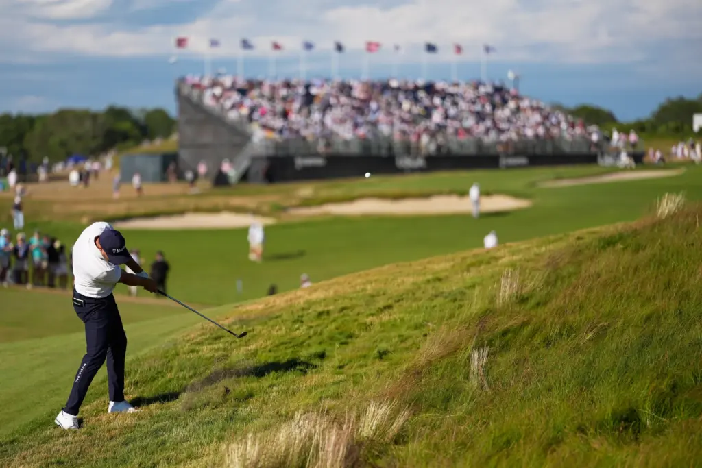 Wyndham Clark hits from the rough on the ninth hole...