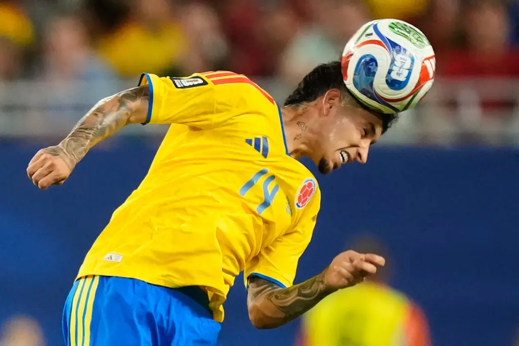 Colombia’s Gustavo Puerta (14) heads the ball during the World...
