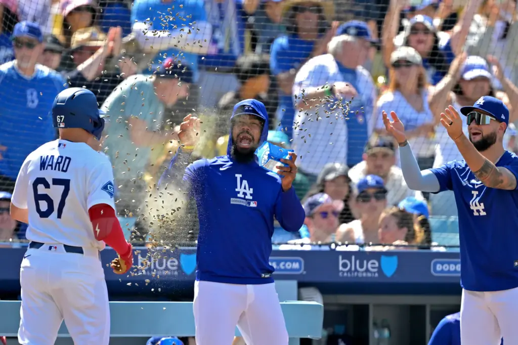 Dodgers’ Ryan Ward (67) gets a sunflower seed shower from...