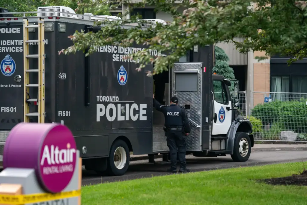 Investigators work the scene where a Toronto Police officer was...
