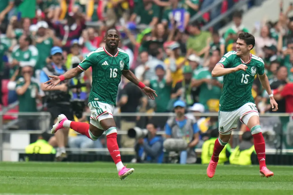 Mexico’s Julian Quinones (16) celebrates with Israel Reyes after scoring...