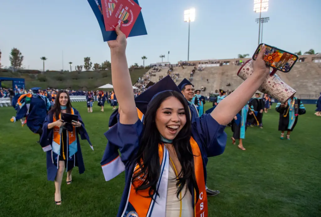 Student leave the ceremonies as graduates after CSUF College of...
