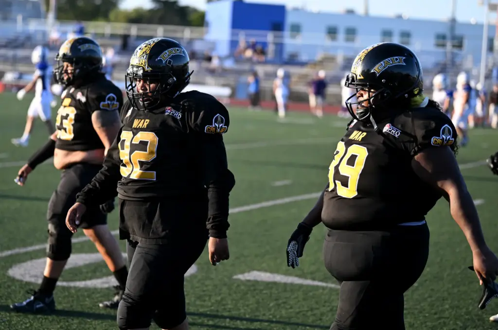 Members of the Cali War offensive line walk off the...