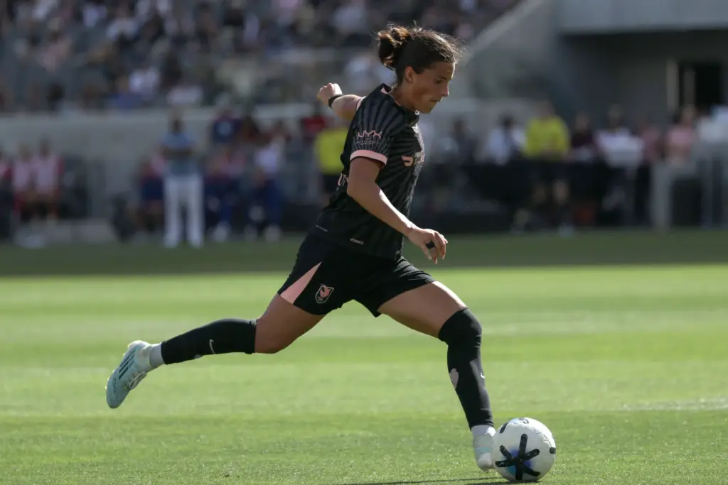 Angel City FC defender Emily Sams winds up to kick...