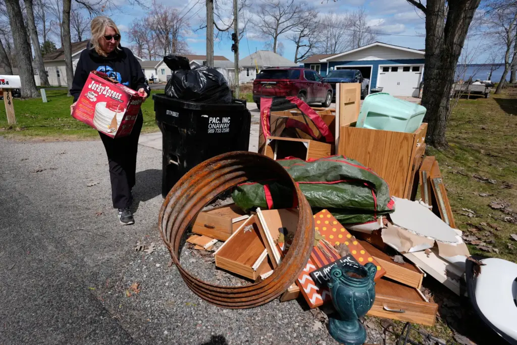 Diane Peterman throws away damaged belongings from recent floods.