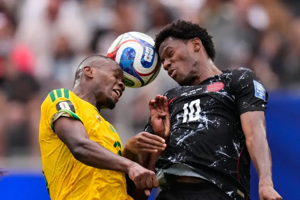 South Africa’s Sphephelo Sithole and Canada’s Jonathan David (10) go...