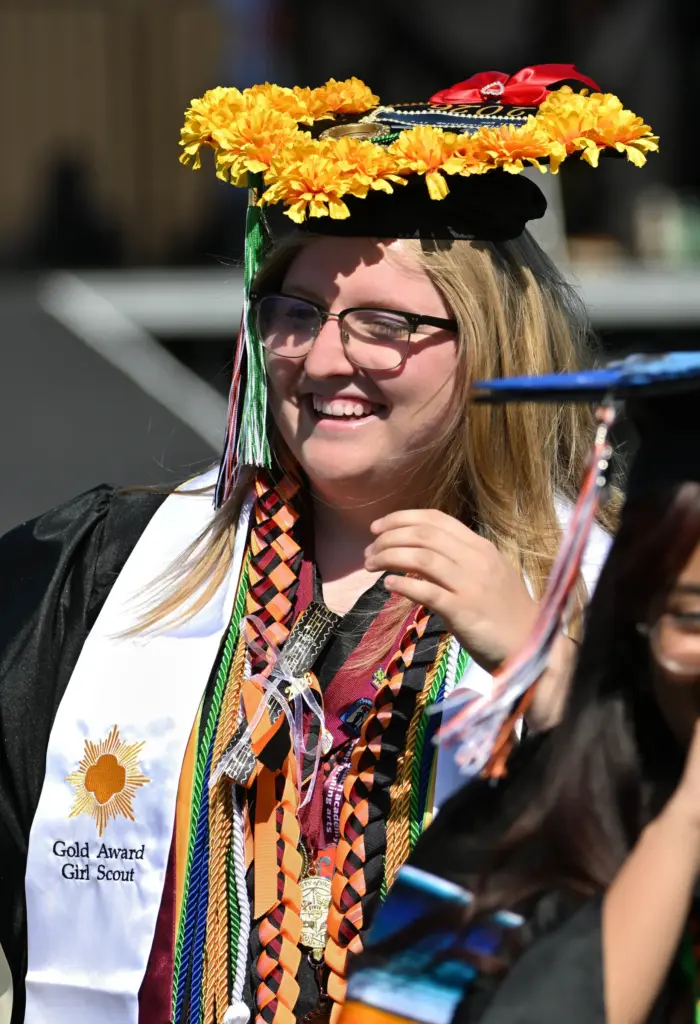 Shannon Mitchell smiles as she walks with her classmates onto...