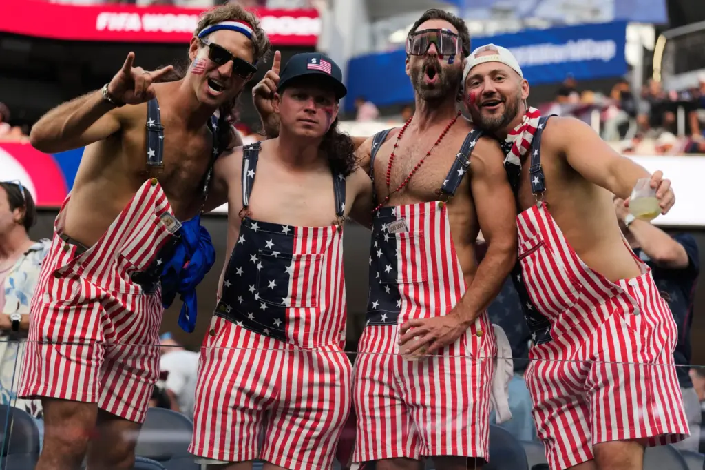Fans of United States pose for a picture prior to...