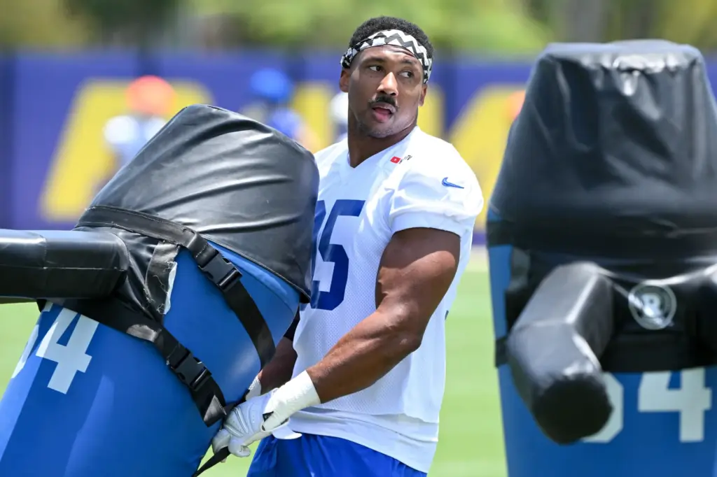 Newly acquired Rams defensive lineman Myles Garrett pulls some equipment...