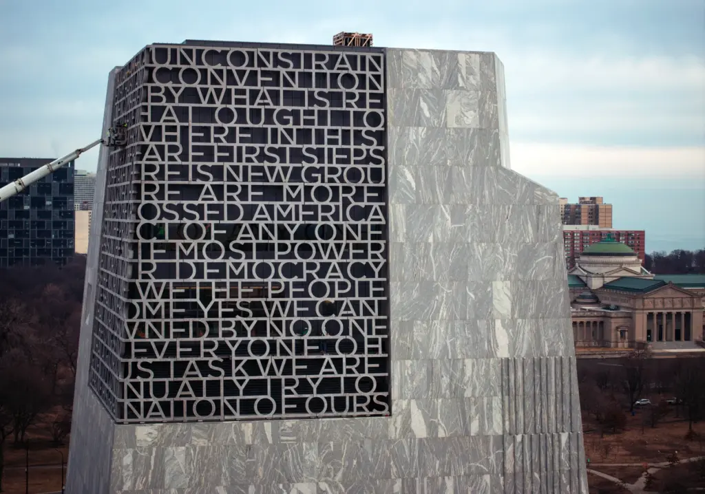 Workers finish installing words from from President Obamaâs speech marking...