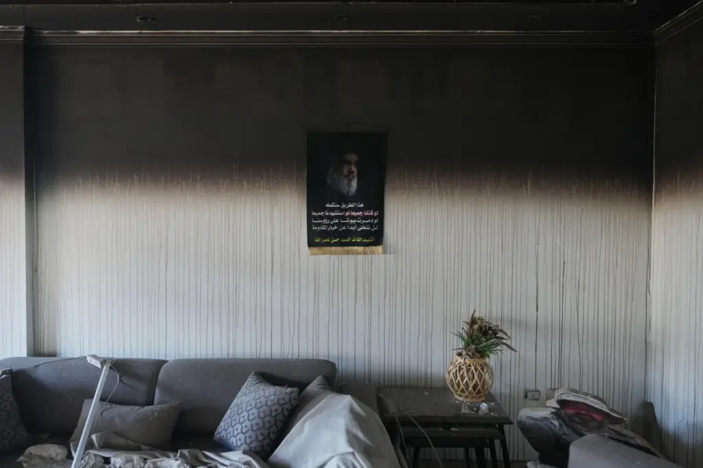A portrait of former Hezbollah leader Hassan Nasrallah hangs on...
